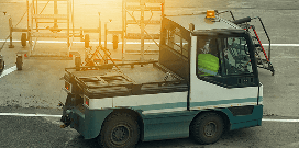 Industrial utility vehicle in a lot in front of other equipment