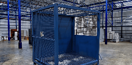 Blue metal storage cage inside a warehouse, designed for secure equipment or material containment.