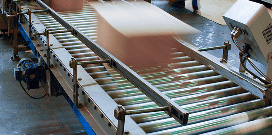 Packages rolling down a conveyor system in a warehouse