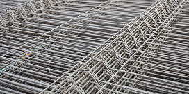 A stack of metal pallet rack decking ready to be placed on a pallet rack